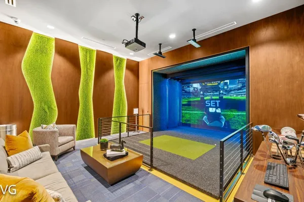 a living room with furniture with floor to ceiling windows and a chandelier