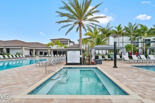 a view of a swimming pool and lounge chairs