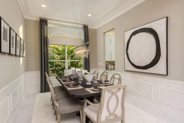 a dining room with furniture and a mirror