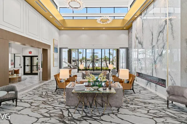 a living room with fireplace furniture and a potted plant