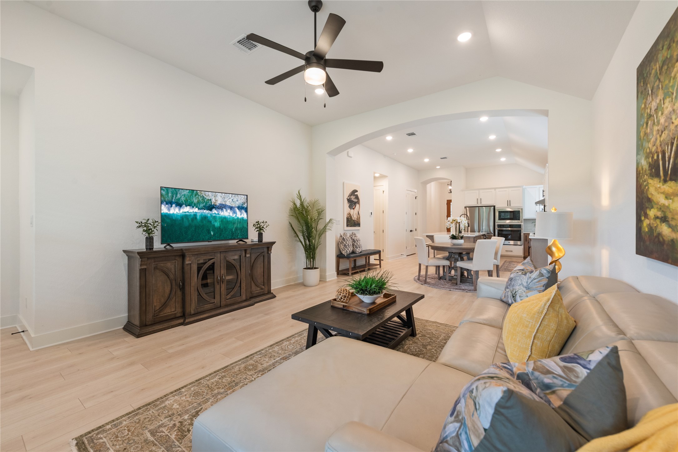 294 Kimble Creek Loop Kyle, TX 78640 - Photo 10 of 40 An inviting open-concept living area with vaulted ceilings seamlessly connects to the dining and kitchen spaces.