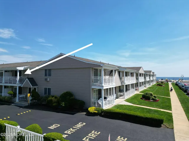 a front view of a house with garden and trees
