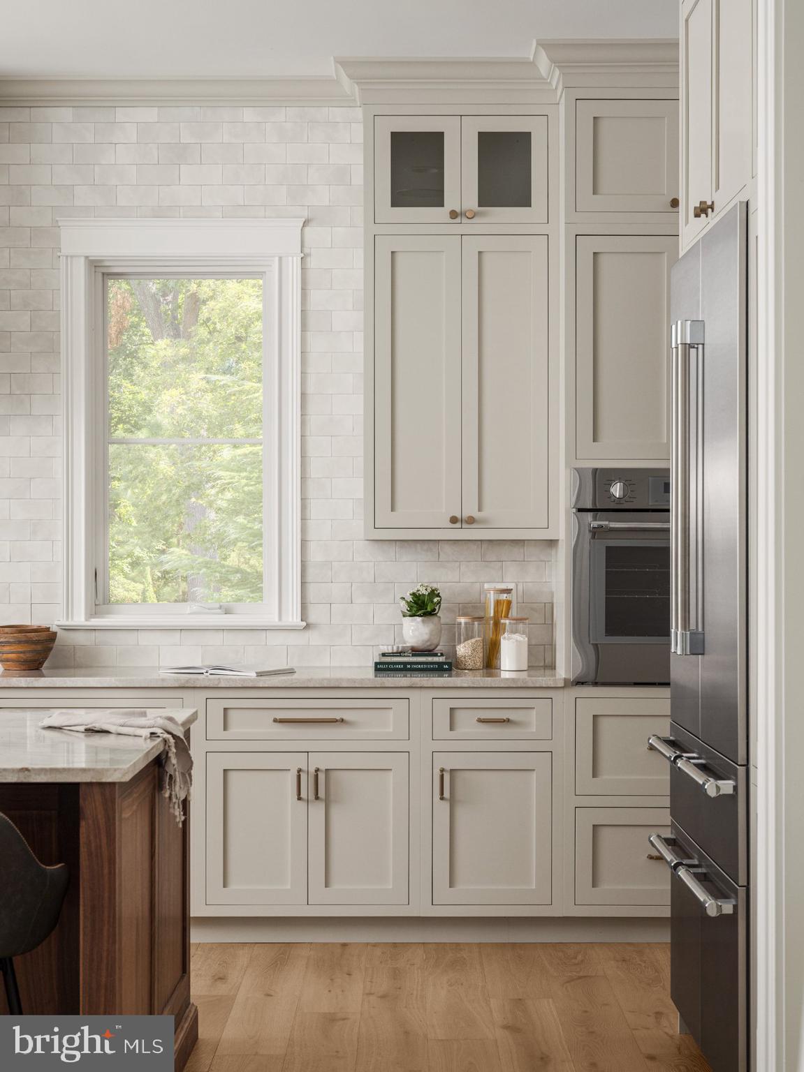502 North Jackson Street Arlington, VA 22201 - Photo 12 of 21 a kitchen with white cabinets and window