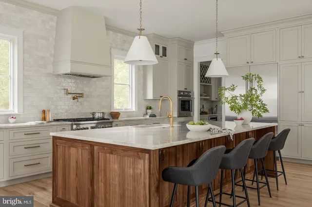 a kitchen with white cabinets and appliances
