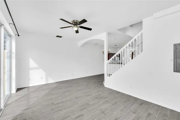 a view of a room with wooden floor and windows