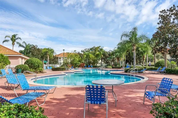a view of swimming pool with outdoor seating and plants