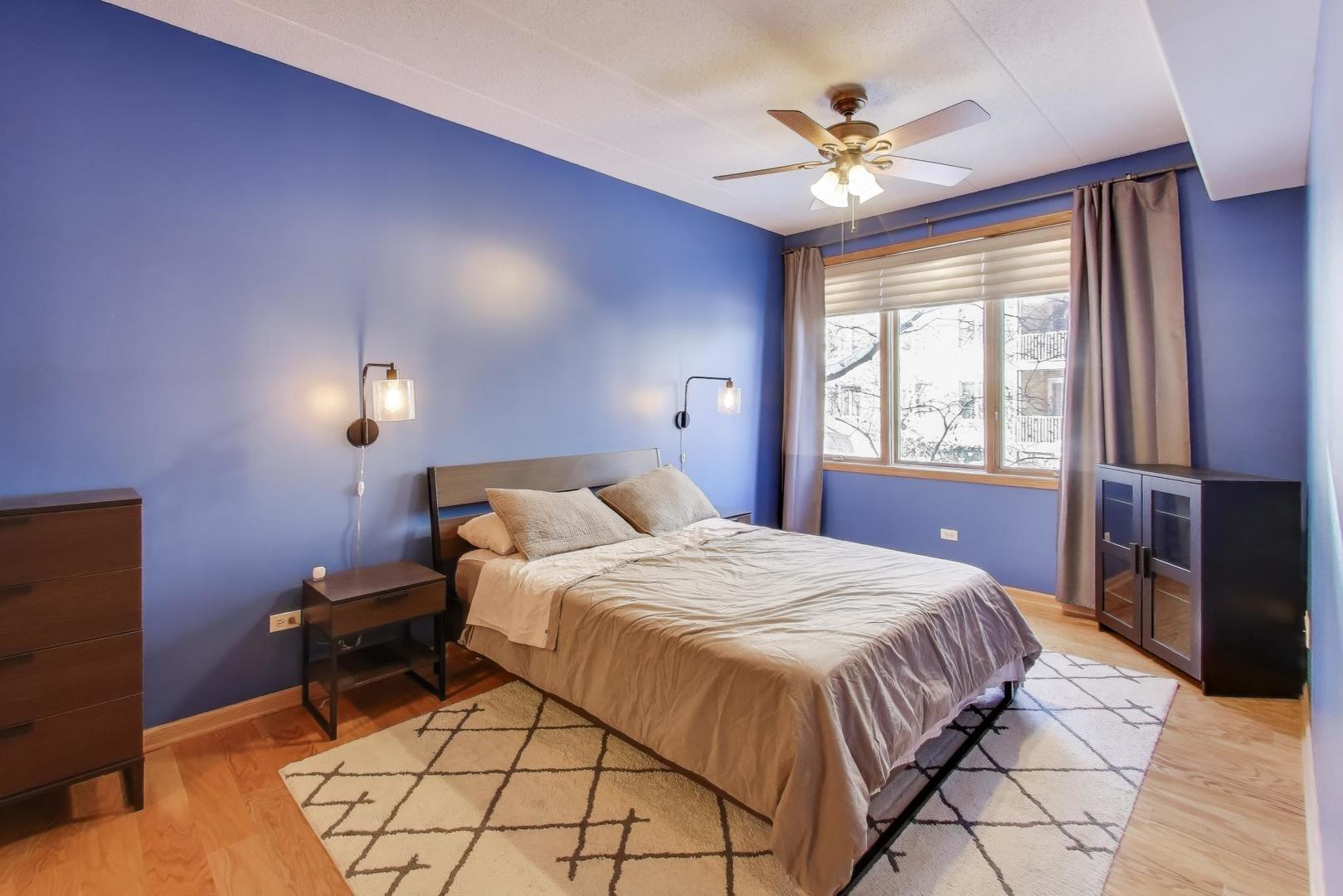 1715 Pavilion Way, Unit 206 Park Ridge, IL 60068 - Photo 10 of 19 a bedroom with a bed and a chandelier