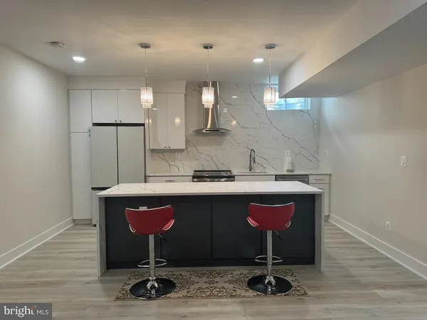 a kitchen with a sink cabinets and wooden floor