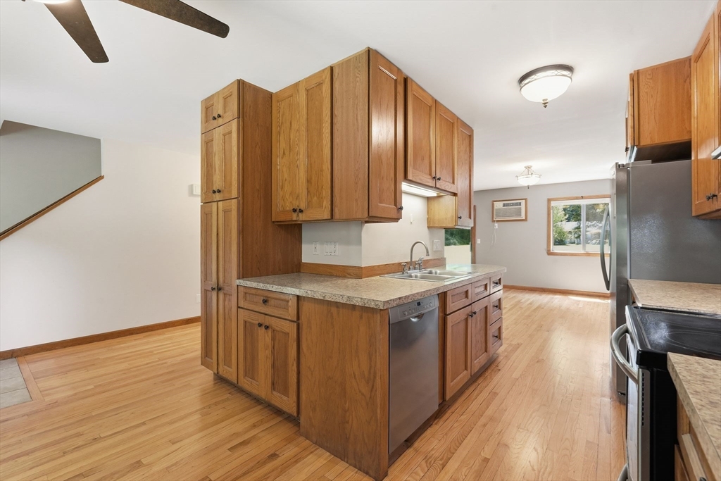 170 East Hadley Road, Unit 96 Amherst, MA 01002 - Photo 5 of 36 a kitchen with stainless steel appliances granite countertop a stove and a wooden floors