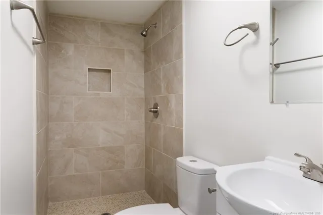 a bathroom with a toilet sink and shower