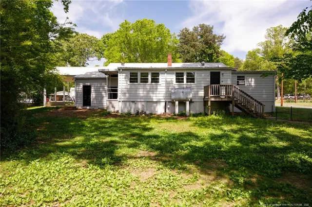 a front view of a house with a yard table and chairs
