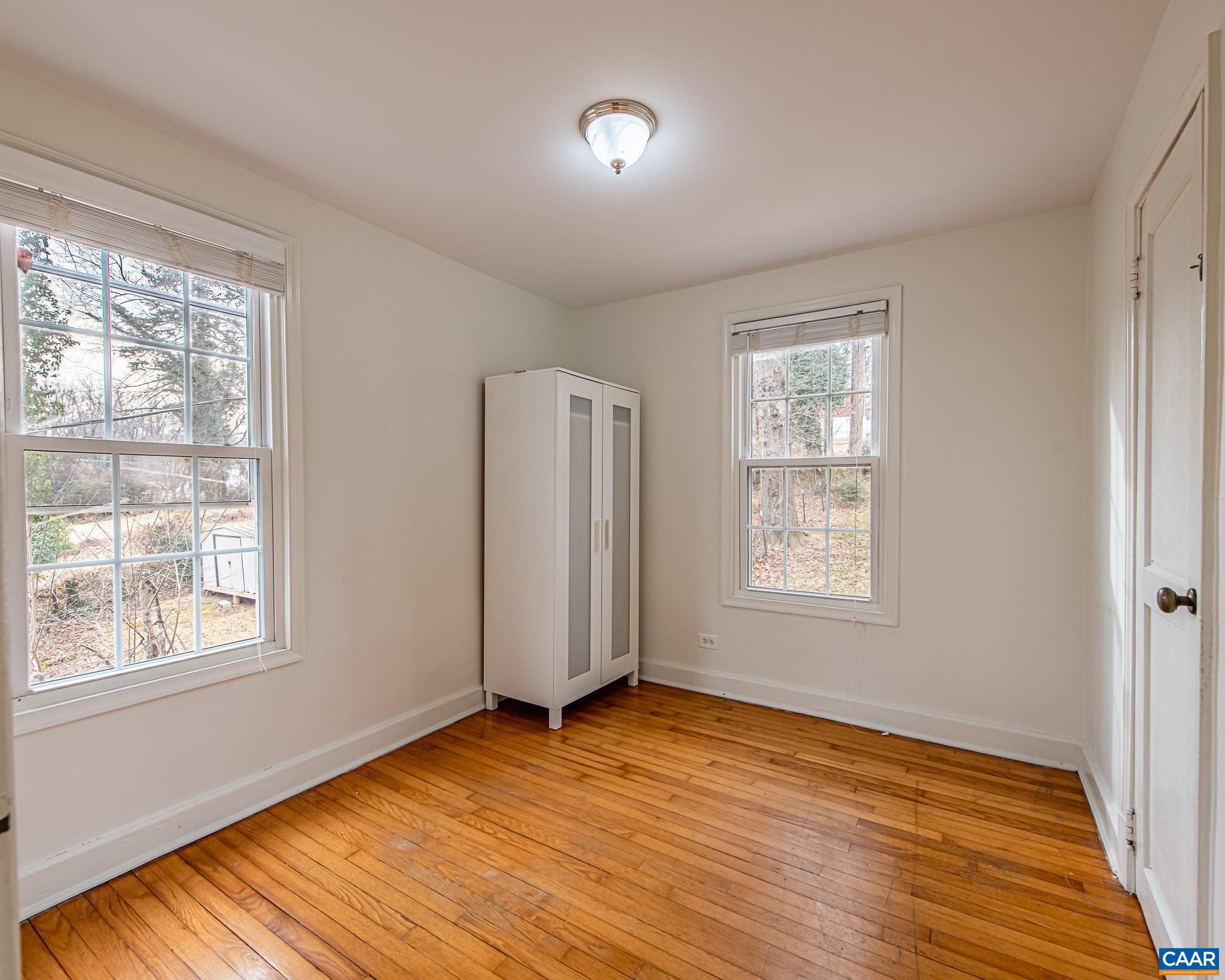 501 Valley Rd Extension Charlottesville, VA 22903 - Photo 15 of 23 a view of an empty room with wooden floor and a window