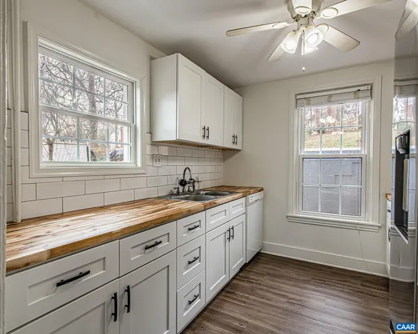 a kitchen with a sink window and cabinets