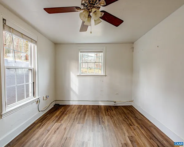 wooden floor in an empty room with a window