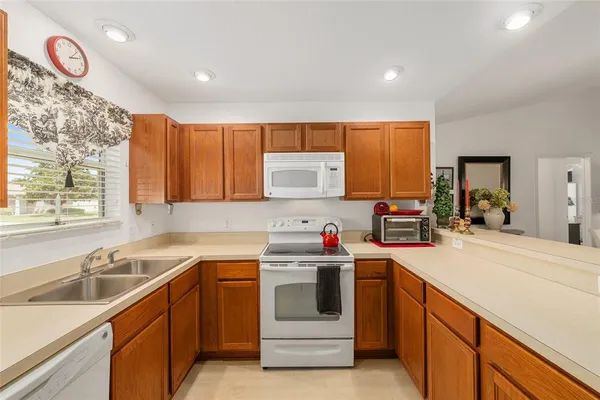 a kitchen with a sink cabinets and window
