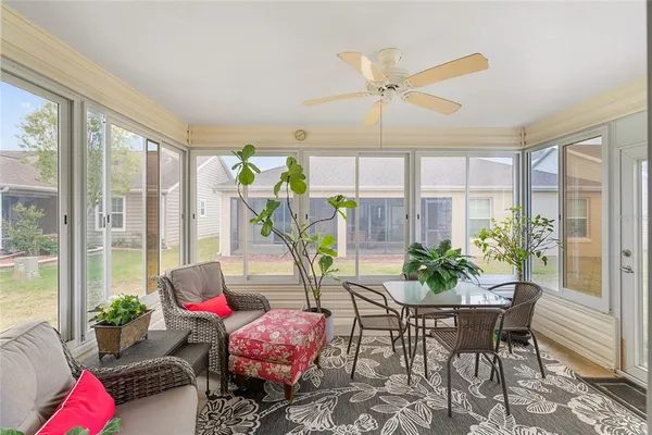 a dining room with furniture a potted plant and a chandelier