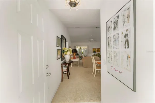 a view of a hallway with closet and a window