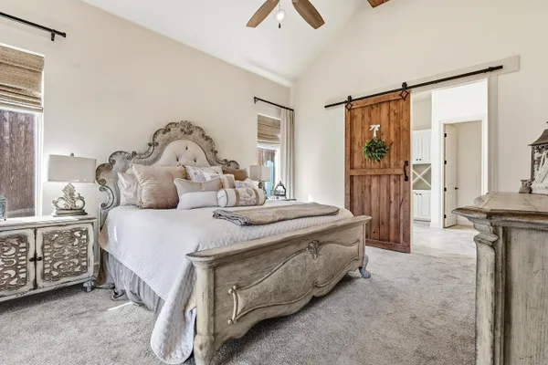 a bedroom with a bed and a chandelier