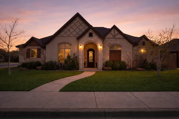 a front view of a house with a garden