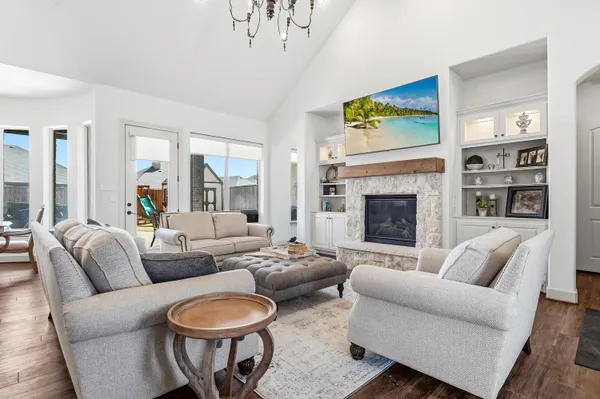 a living room with furniture a fireplace and a large window