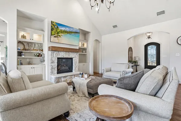a living room with furniture and a fireplace