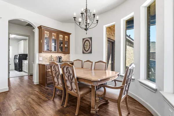 a view of a dining room with furniture wooden floor and chandelier