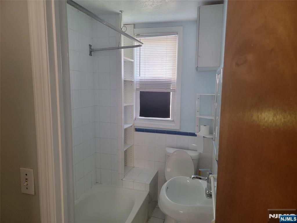 165 Corabelle Avenue, Unit 2 Lodi, NJ 07644 - Photo 7 of 7 a bathroom with a toilet and a sink