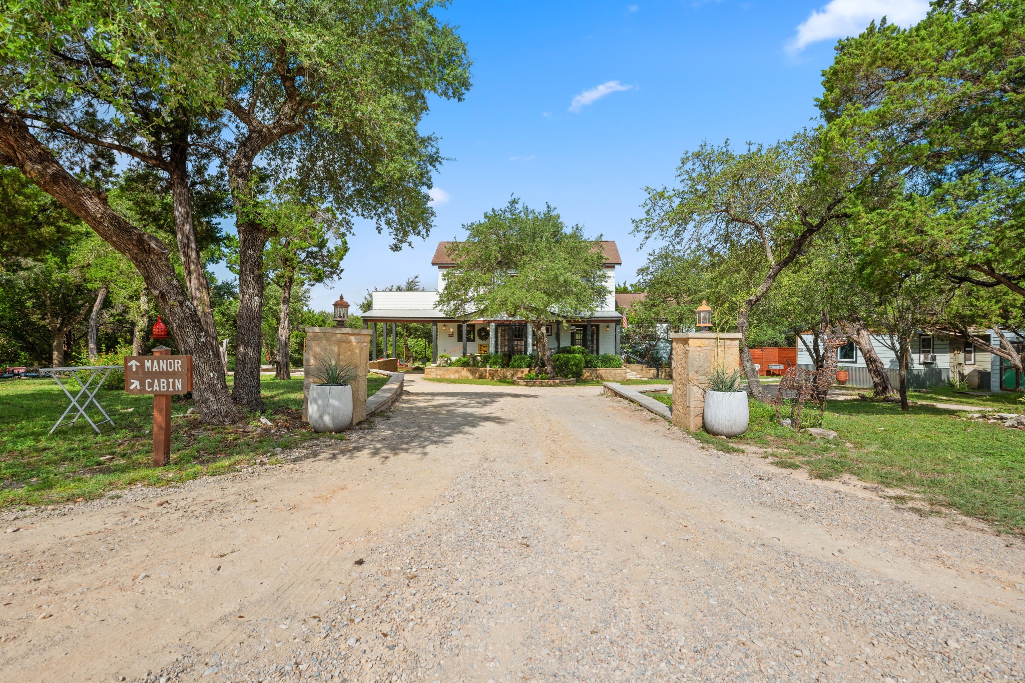 12932 Nutty Brown Road Austin, TX 78737 - Photo 2 of 40 Welcome to this rare 6.283-acre Hill Country compound, where The Manor welcomes you to a one-of-a-kind property featuring four residences surrounded by mature oaks and scenic Texas Hill Country landscapes.