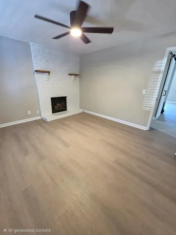 an empty room with fireplace and windows