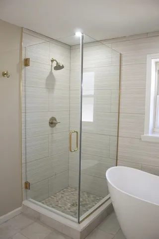 a bathroom with a bathtub and shower