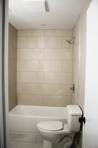 a bathroom with a toilet and a bathtub