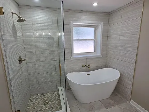 a bathroom with a bathtub and shower