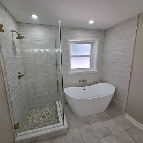 a bathroom with a sink a toilet a mirror and shower