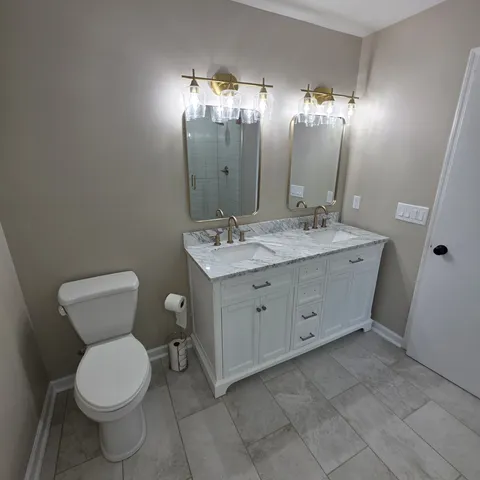 a bathroom with a toilet sink and mirror