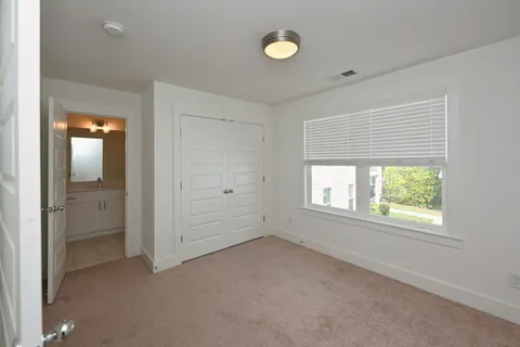 an empty room with windows and closet