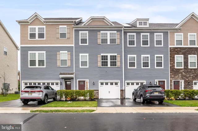 a car parked in front of a brick house