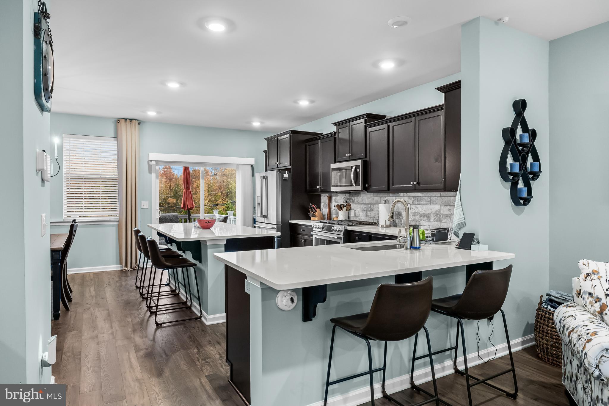 10 Naples Lane Mount Laurel, NJ 08054 - Photo 11 of 27 a kitchen with stainless steel appliances granite countertop a stove a refrigerator a sink a dining table and chairs
