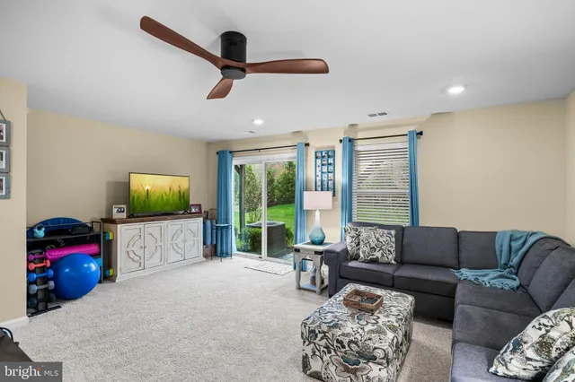 a living room with furniture window and a flat screen tv