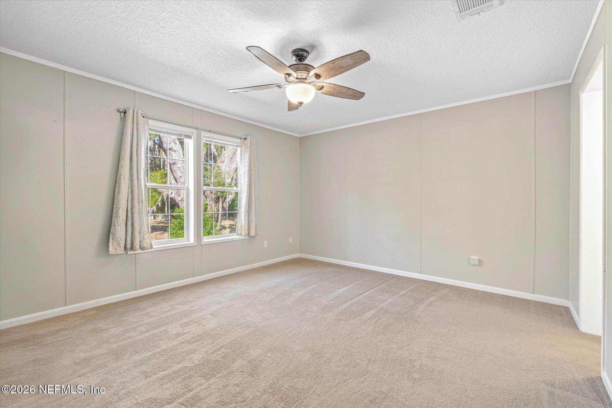 130 Sisco Road Pomona Park, FL 32181 - Photo 14 of 43 an empty room with window and ceiling fan