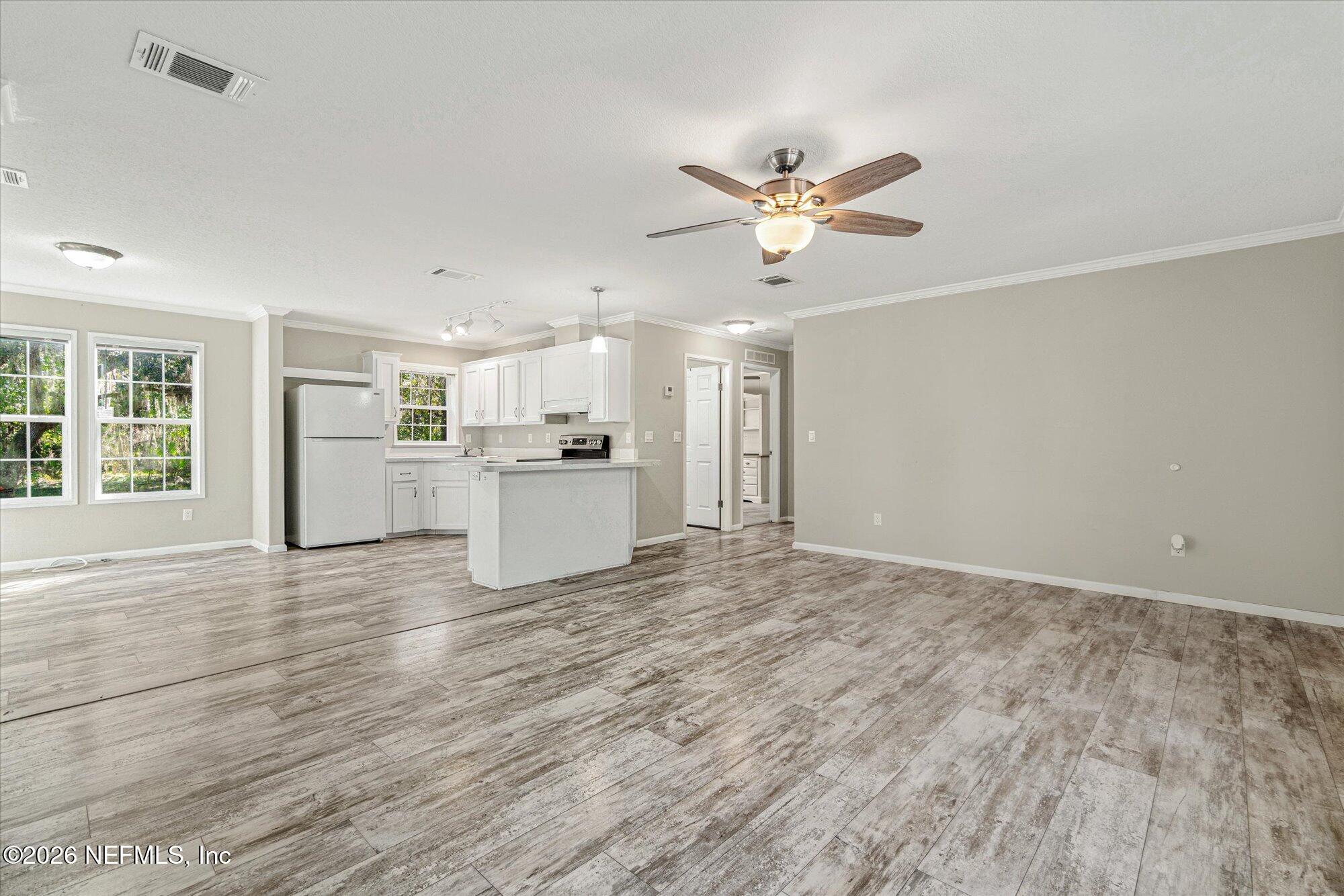 130 Sisco Road Pomona Park, FL 32181 - Photo 21 of 43 a view of empty room with wooden floor and window