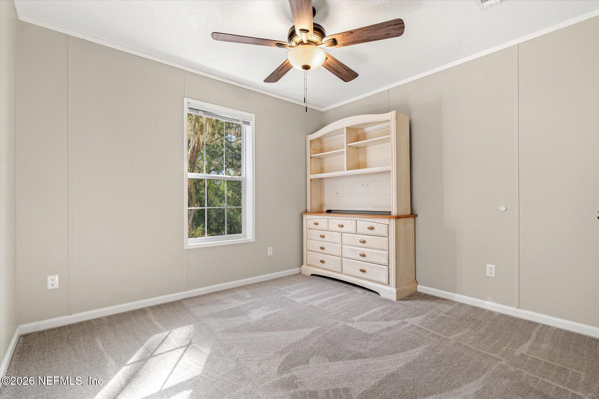 130 Sisco Road Pomona Park, FL 32181 - Photo 22 of 43 an empty room with windows and cabinet