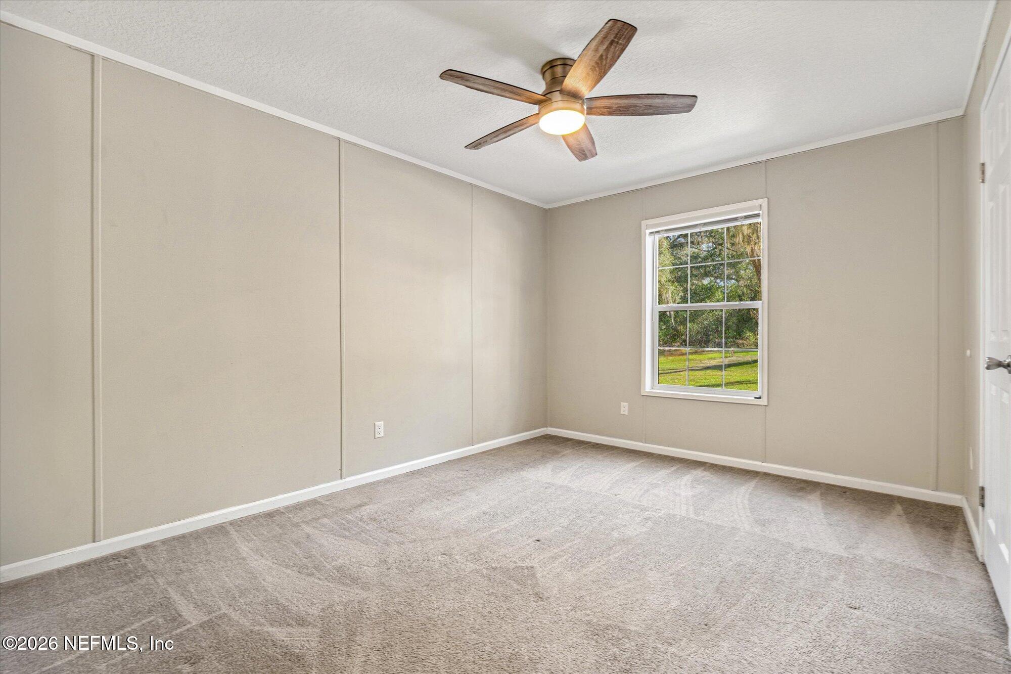 130 Sisco Road Pomona Park, FL 32181 - Photo 25 of 43 an empty room with windows and fan