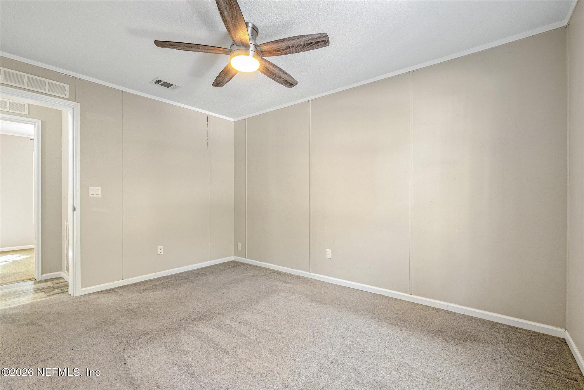 130 Sisco Road Pomona Park, FL 32181 - Photo 26 of 43 an empty room with a ceiling fan and wooden floor