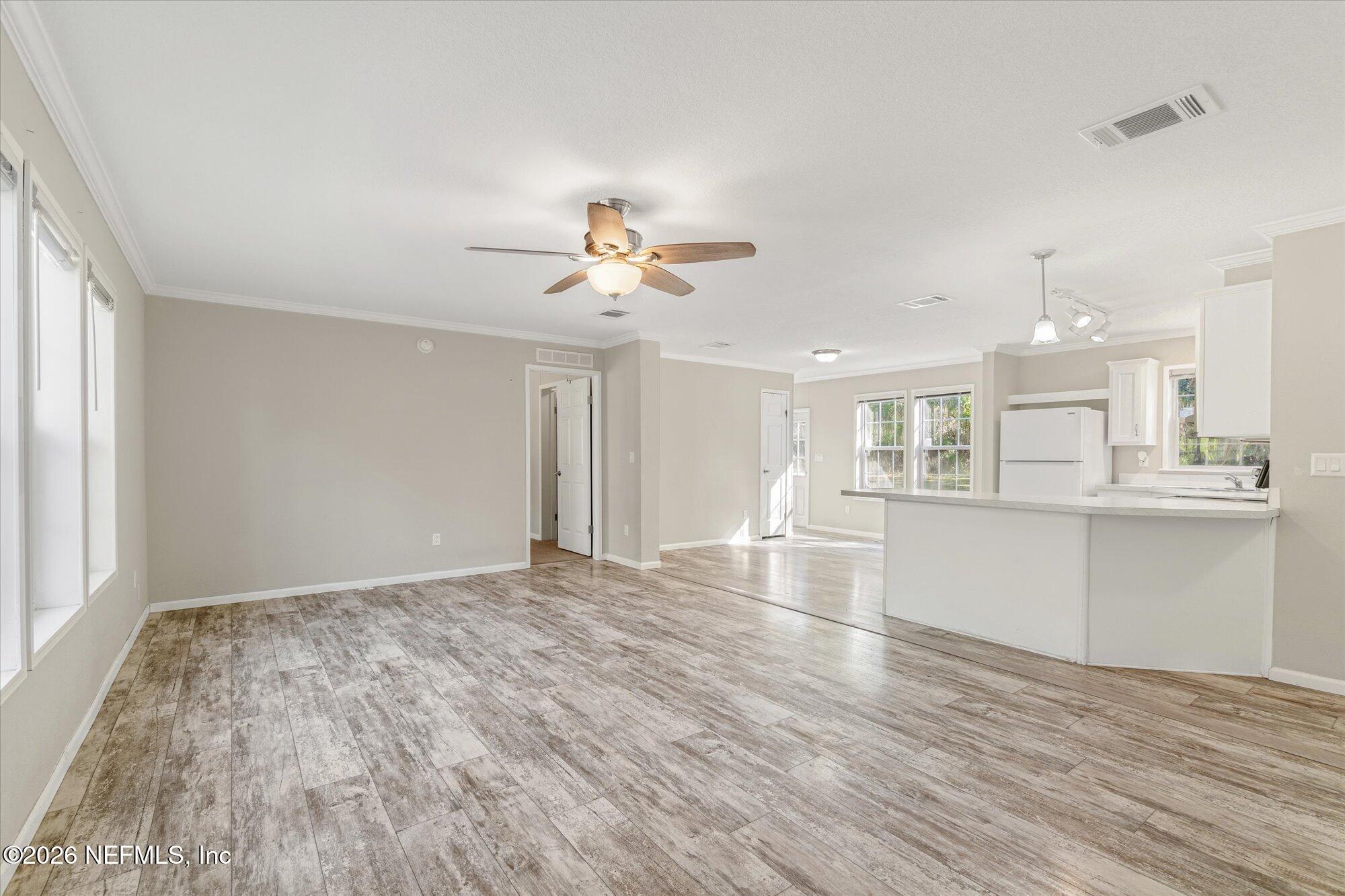 130 Sisco Road Pomona Park, FL 32181 - Photo 6 of 43 a view of an empty room with wooden floor and a window