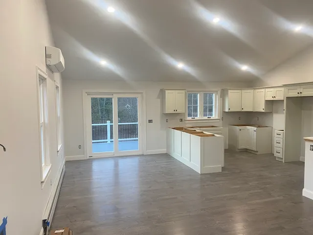 a kitchen with white cabinets and white appliances