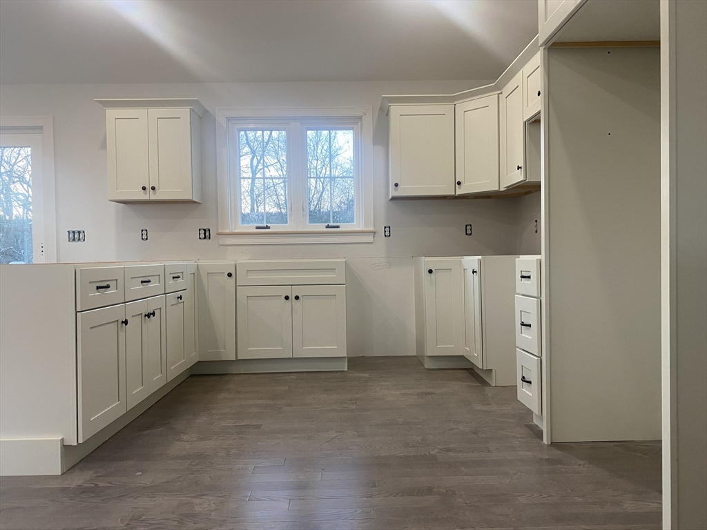 572 Wheelwright Road Barre, MA 01005 - Photo 6 of 8 a kitchen with white cabinets and white appliances
