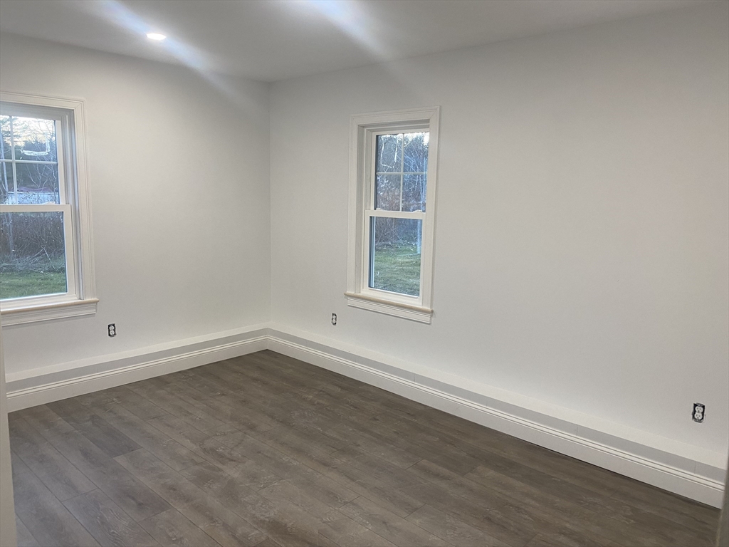 572 Wheelwright Road Barre, MA 01005 - Photo 8 of 8 an empty room with wooden floor and windows