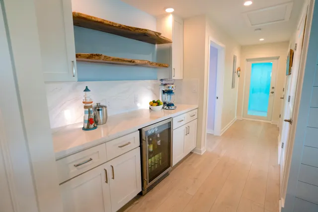 a kitchen with white cabinets and white appliances