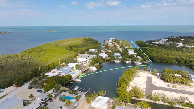 an aerial view of a house with a ocean view