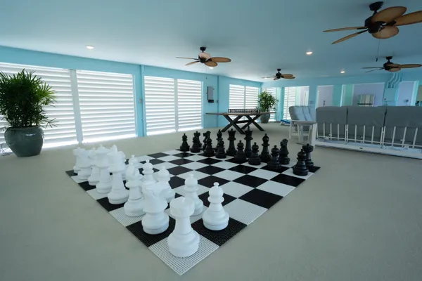 a room with lots of white furniture and window